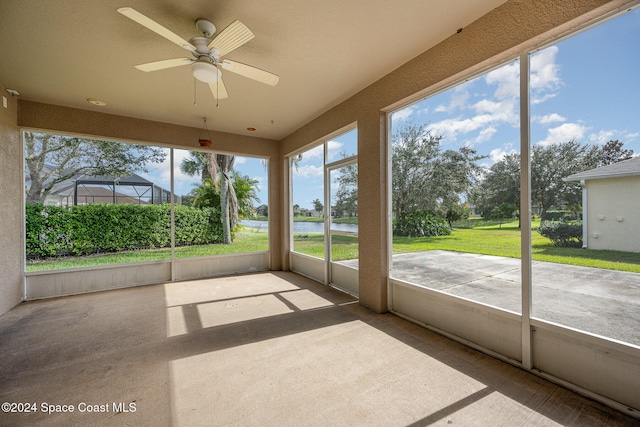 unfurnished sunroom featuring ceiling fan