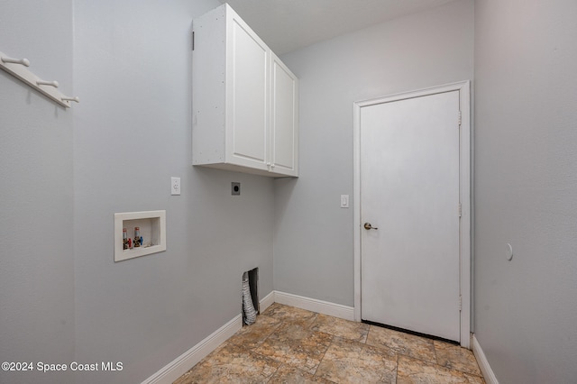 clothes washing area featuring electric dryer hookup, cabinets, and washer hookup