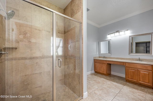 bathroom featuring a textured ceiling, vanity, crown molding, tile patterned flooring, and a shower with shower door