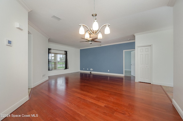 empty room with hardwood / wood-style flooring, ceiling fan with notable chandelier, and ornamental molding