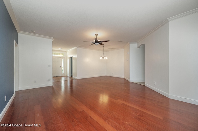 empty room featuring ornamental molding, ceiling fan with notable chandelier, and hardwood / wood-style flooring