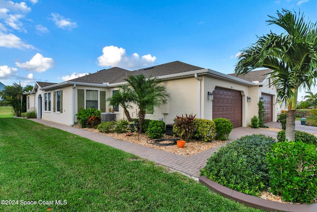 single story home with a front yard and a garage