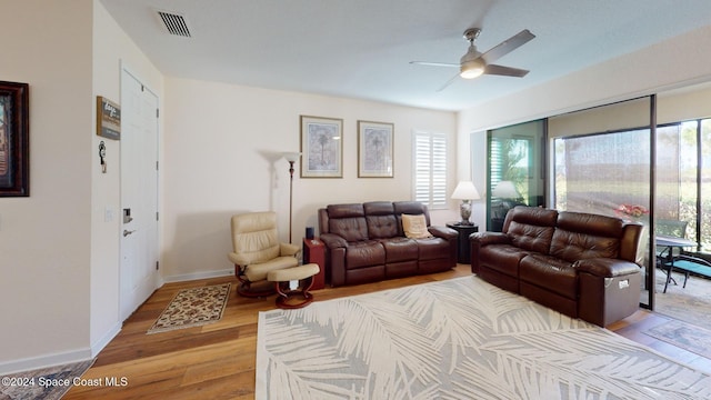 living room featuring hardwood / wood-style flooring, plenty of natural light, and ceiling fan