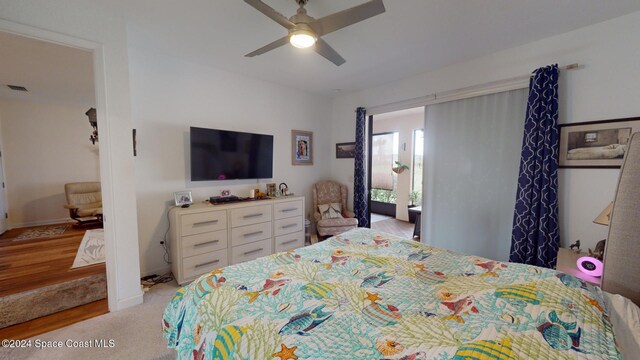 bedroom with ceiling fan and light carpet