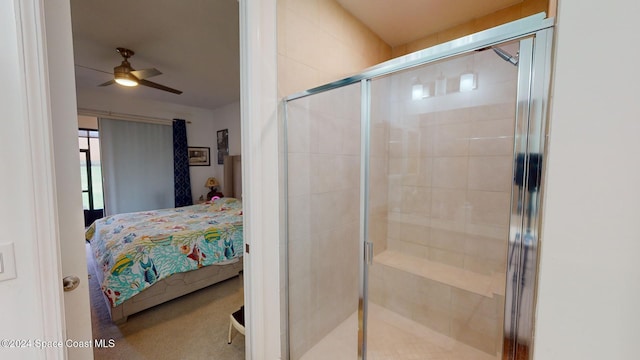 bathroom with a shower with door and ceiling fan