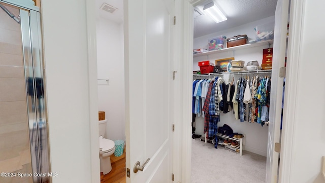 interior space featuring walk in shower and toilet