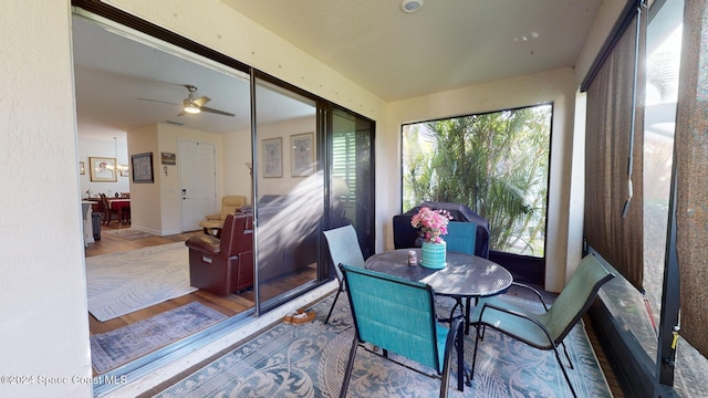 sunroom / solarium featuring ceiling fan