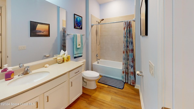 full bathroom with hardwood / wood-style flooring, vanity, toilet, and shower / tub combo with curtain