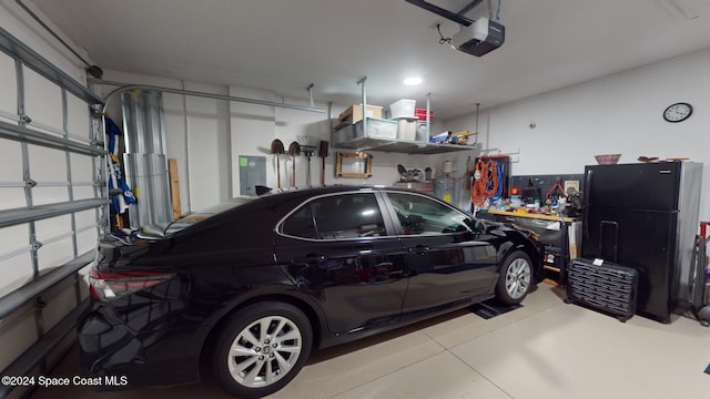 garage with electric panel and a garage door opener