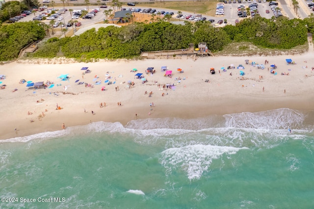 bird's eye view with a water view and a beach view