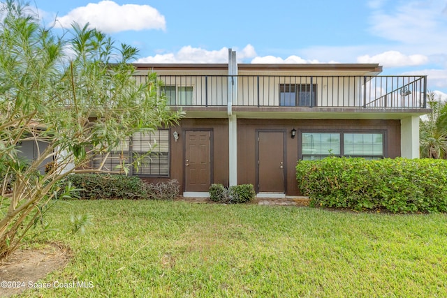 back of property featuring a lawn