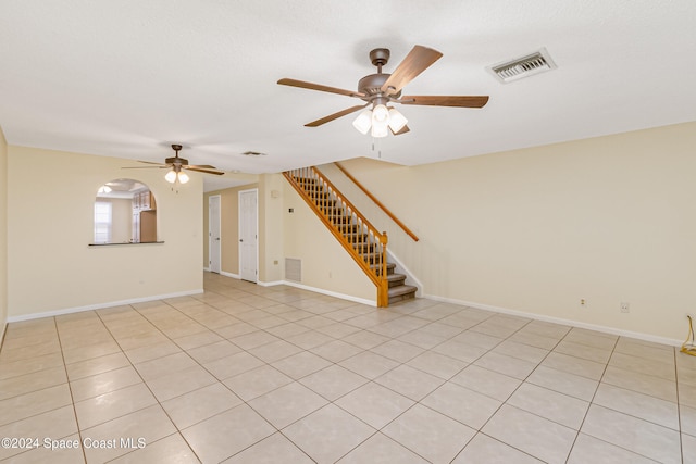 unfurnished living room with light tile patterned floors and ceiling fan