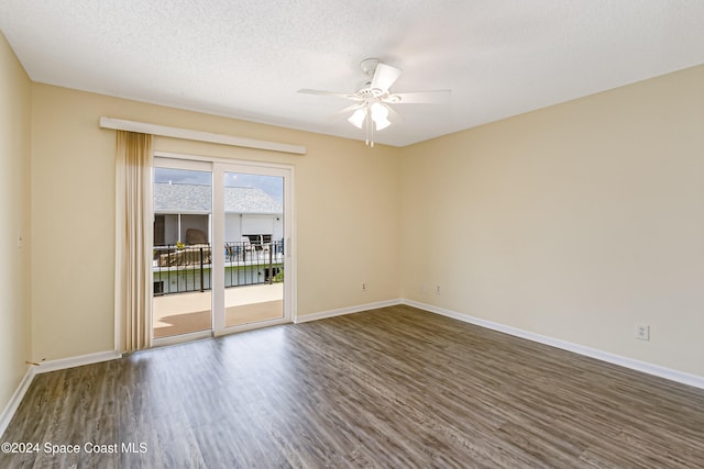 spare room with ceiling fan, dark hardwood / wood-style flooring, and a textured ceiling