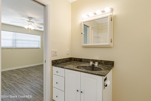 bathroom featuring wood-type flooring, vanity, and ceiling fan