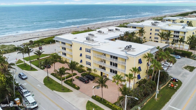 aerial view featuring a view of the beach and a water view