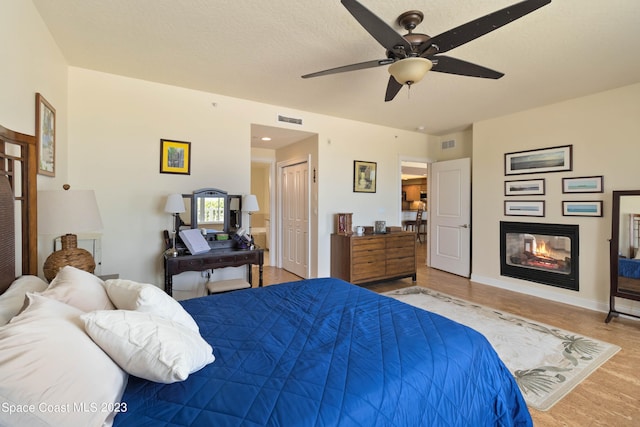 bedroom with ceiling fan and light wood-type flooring