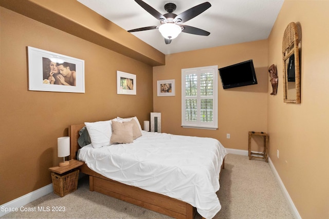 bedroom featuring light carpet and ceiling fan