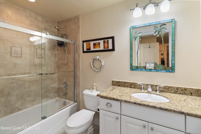 full bathroom with vanity, toilet, shower / bath combination with glass door, and a textured ceiling