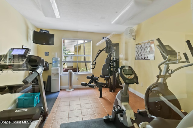 workout area featuring light tile patterned floors