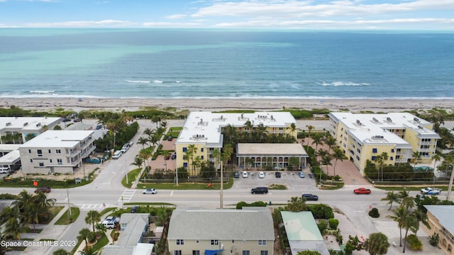 drone / aerial view featuring a view of the beach and a water view