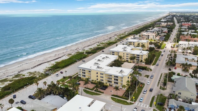 birds eye view of property with a view of the beach and a water view