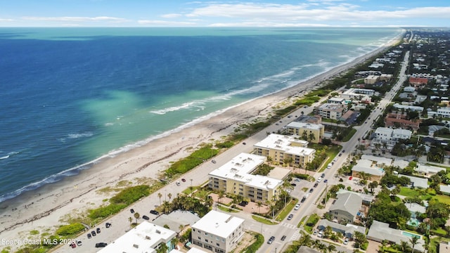 drone / aerial view featuring a water view and a beach view