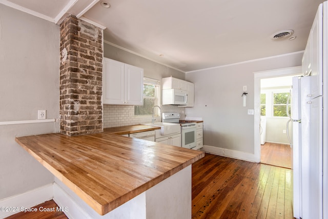 kitchen with white cabinets, dark hardwood / wood-style flooring, wooden counters, white appliances, and kitchen peninsula