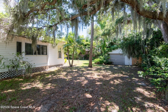 view of yard featuring an outdoor structure and a garage