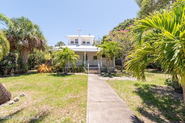 view of front of home with a front yard and a porch