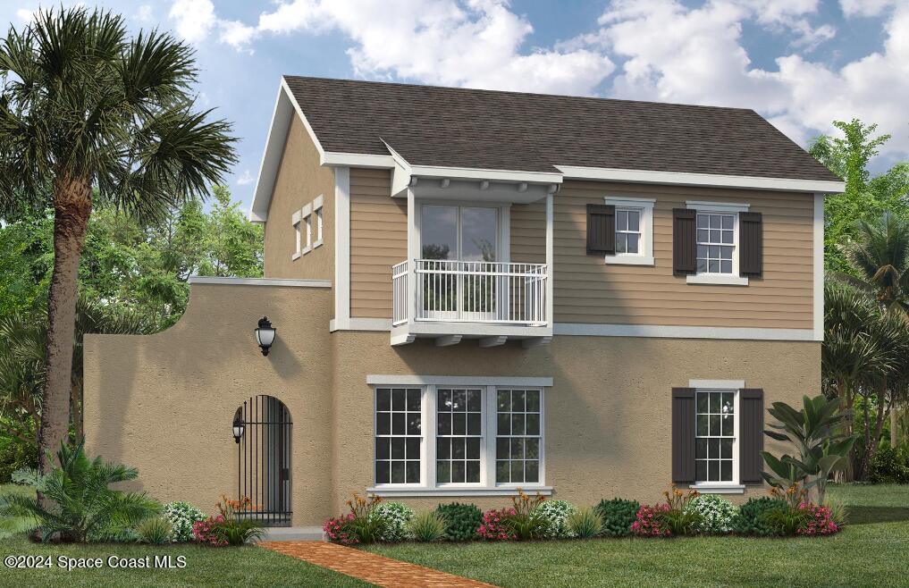 view of front of house with a balcony and a front lawn