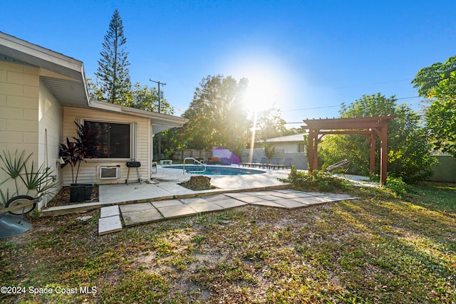 view of yard featuring a fenced in pool, a pergola, and a patio