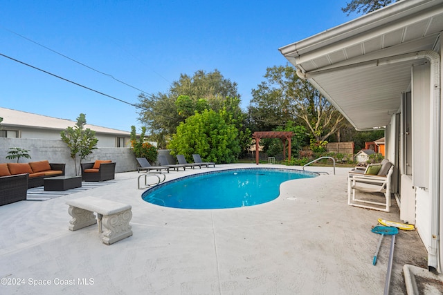 view of swimming pool featuring an outdoor living space and a patio area