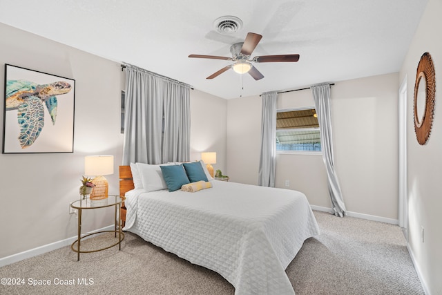 bedroom with ceiling fan and light carpet