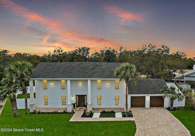 view of front of property featuring a lawn and a garage