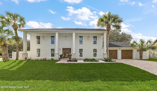 view of front of home featuring a front yard and a garage