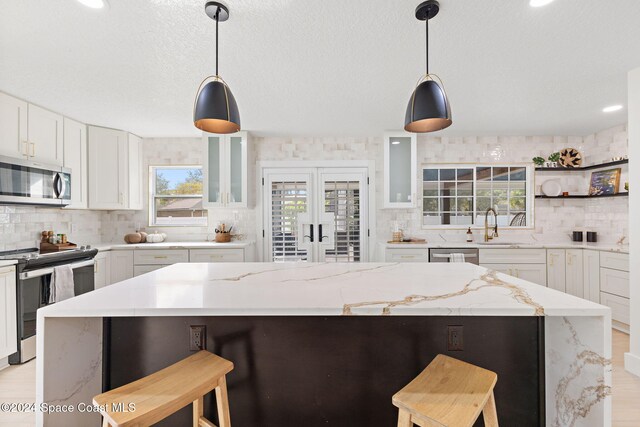 kitchen featuring a kitchen breakfast bar, light hardwood / wood-style flooring, and stainless steel appliances