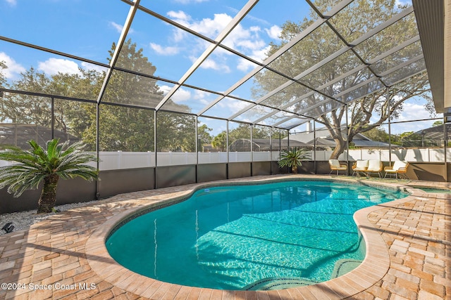 view of pool with a lanai and a patio