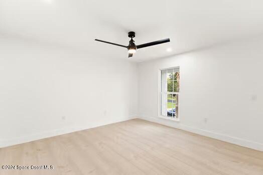 spare room with ceiling fan and light hardwood / wood-style flooring