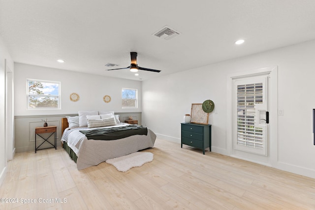 bedroom featuring multiple windows, ceiling fan, and light hardwood / wood-style floors