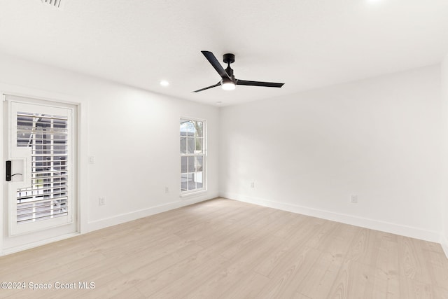 unfurnished room with light hardwood / wood-style flooring, a wealth of natural light, and ceiling fan