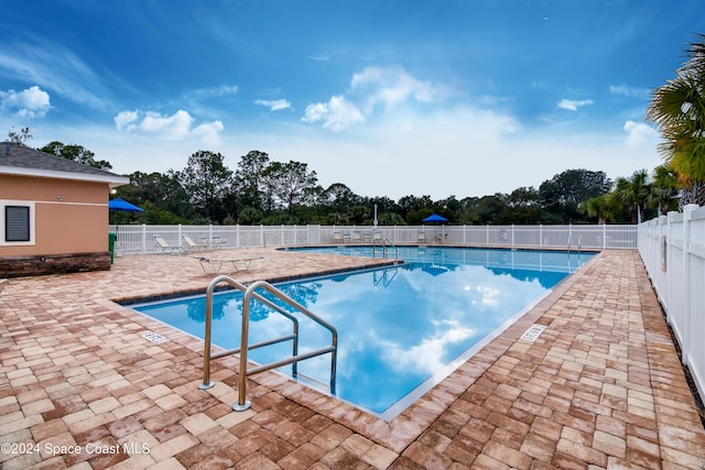 1284 Mycroft Dr, Cocoa, FL 32926 - community pool with a patio area and view of wooded area