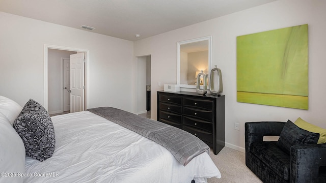 carpeted bedroom featuring visible vents and baseboards