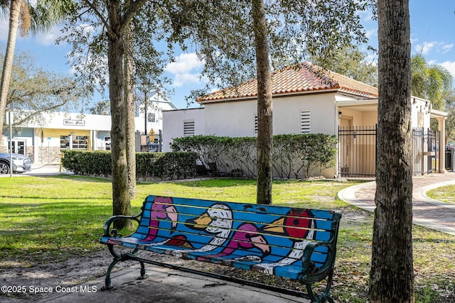 view of property's community featuring a yard and fence