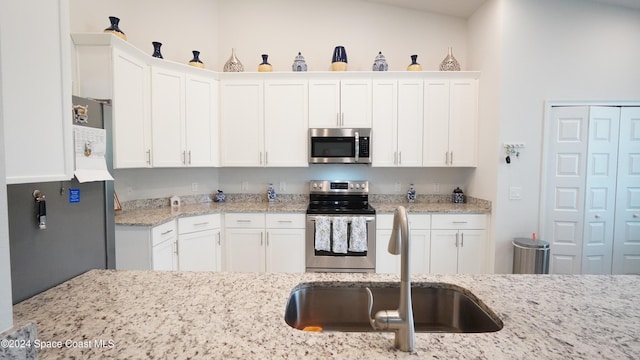 kitchen featuring white cabinetry, sink, and appliances with stainless steel finishes