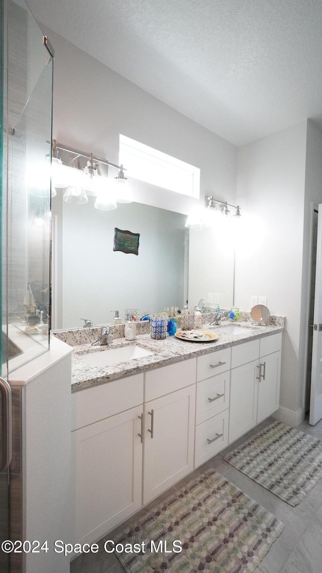 bathroom with vanity and a textured ceiling