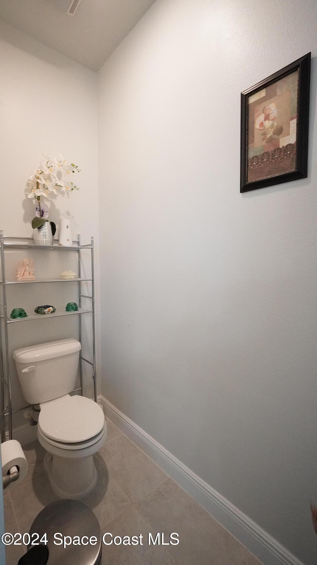 bathroom featuring tile patterned flooring and toilet