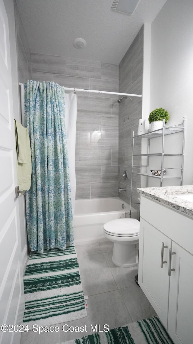 full bathroom featuring tile patterned flooring, vanity, shower / bath combination with curtain, and toilet