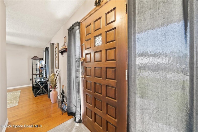 entryway featuring a textured ceiling and hardwood / wood-style flooring