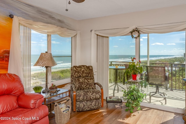 living area featuring a water view, a wealth of natural light, and wood finished floors