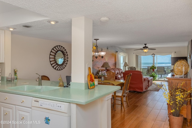 kitchen featuring white dishwasher, white cabinetry, light hardwood / wood-style floors, and sink